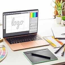 Graphic design studio with logo design on laptop screen